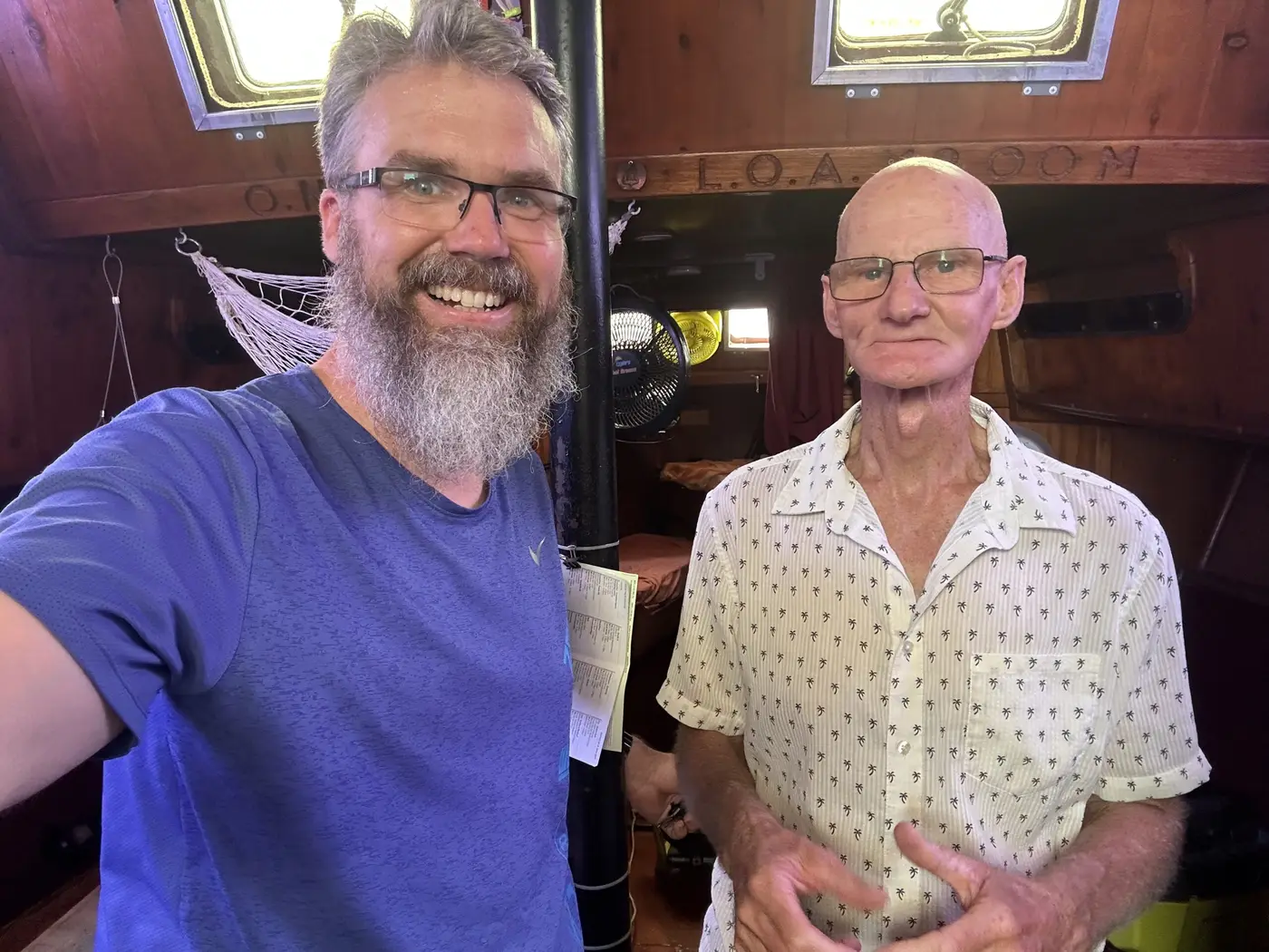 A smiling selfie with a local host beside his yacht in Darwin.