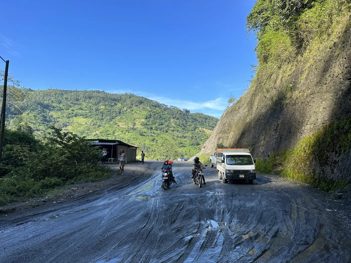 Riding cautiously through a flooded, muddy stretch of road.