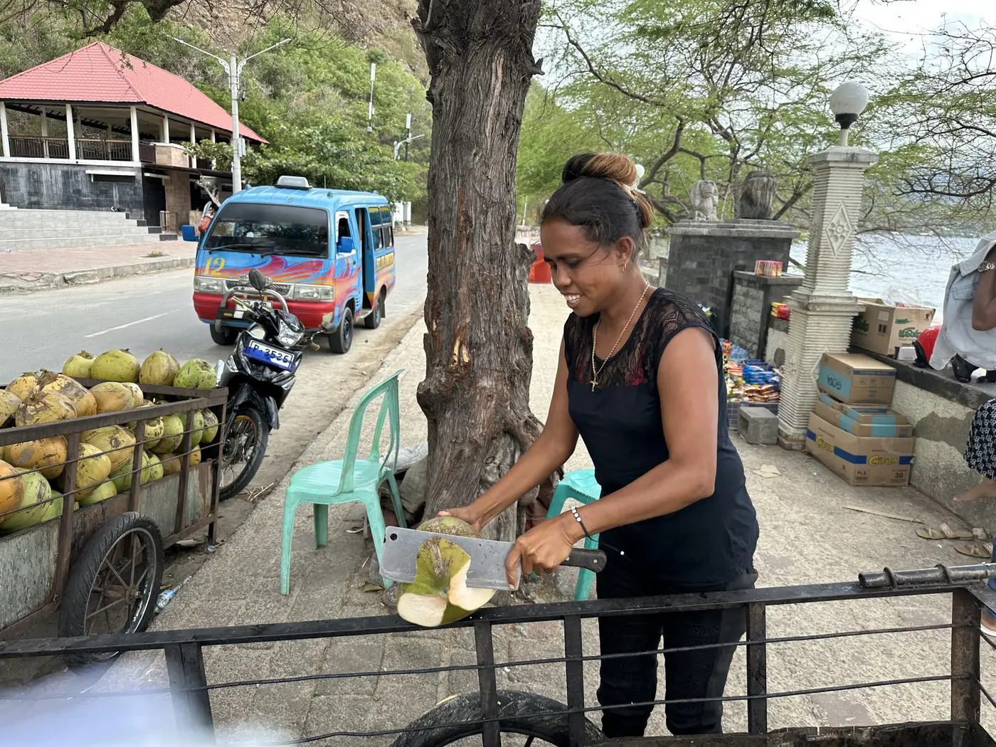 Preparing the purchase of coconut water @ US$1. Very refreshing — Timor-Leste.