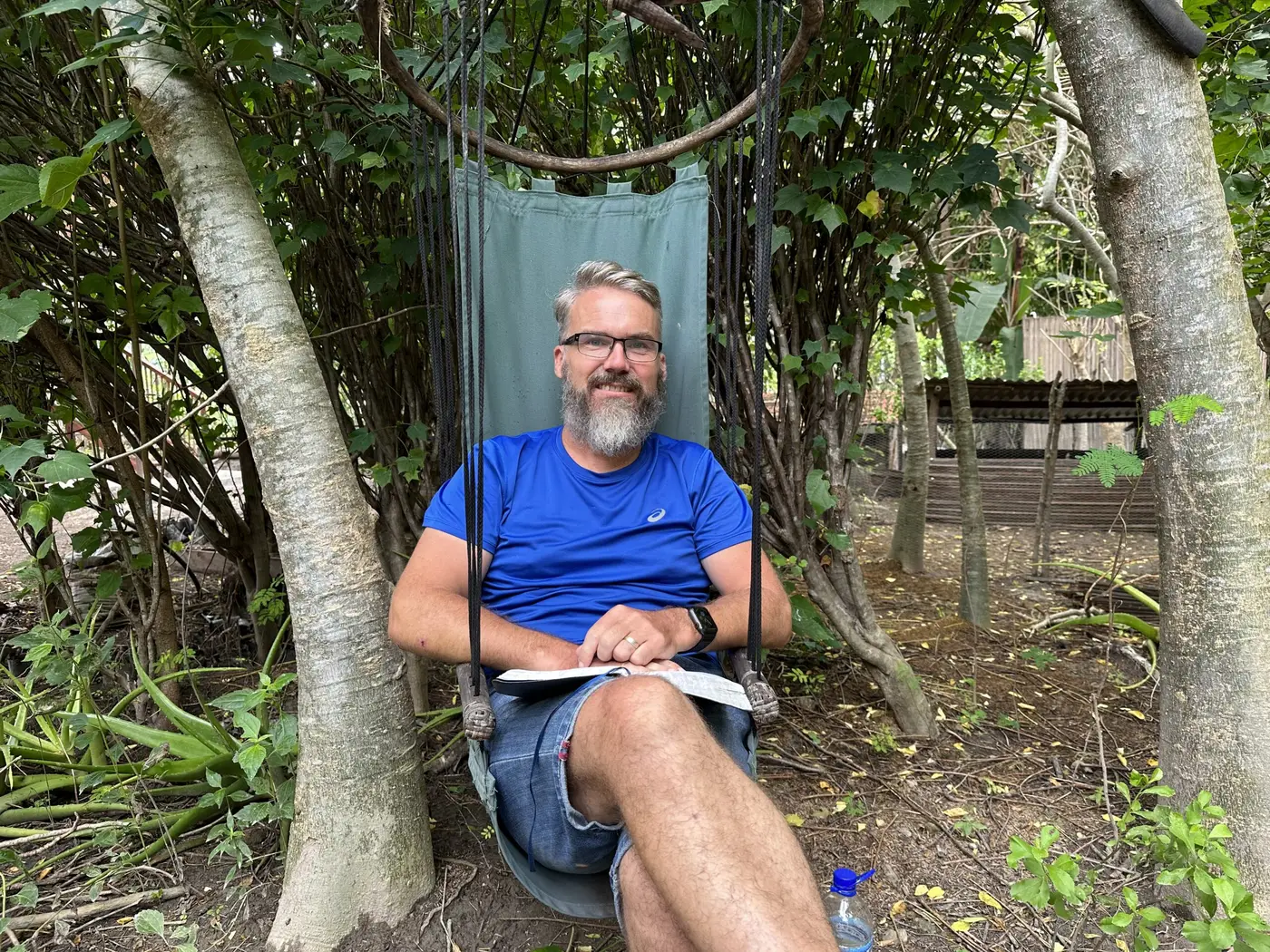 Reading by the fire-pit, minus the fire — Timor-Leste.